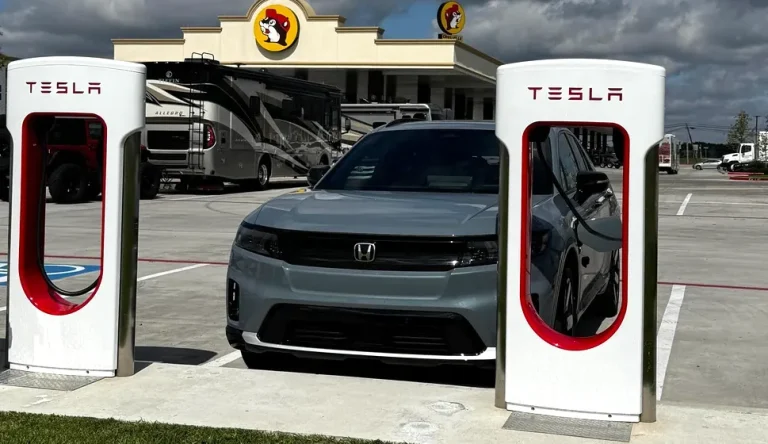 Can Honda Prologue Use Tesla Charger? A Honda Prologue is shown charging at a Tesla Supercharger equipped with Magic Dock for non-Tesla EV compatibility.