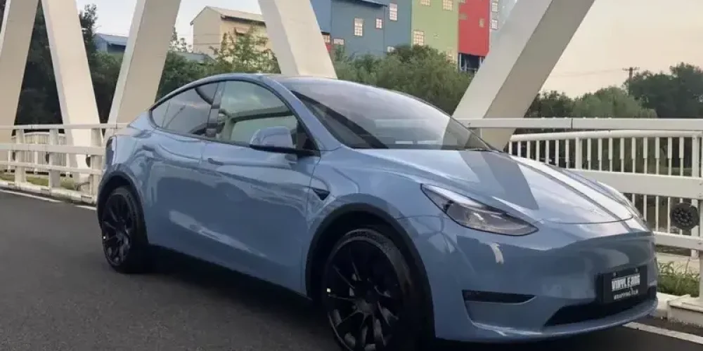 Light Blue Tesla Model Y on the bridge